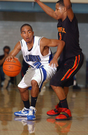 Pali junior point guard Dominick Brown (22) wards off a Fairfax defender on January 19. Brown had five points and a season-high six rebounds in the Dolphins' 67-52 win at Fairfax on February 4